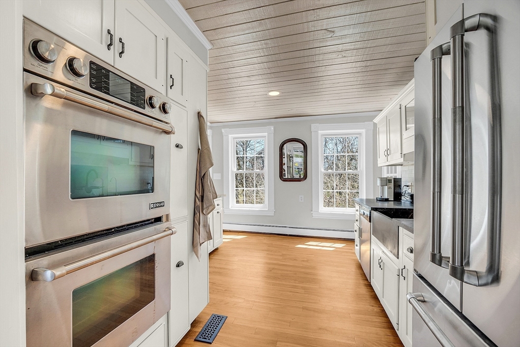 47 Center Bridge Road Lancaster, MA 01523 - Photo 22 of 42 a view of a kitchen with fridge and wooden floor