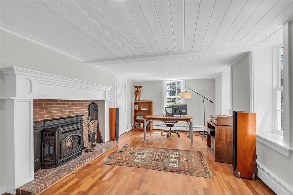 47 Center Bridge Road Lancaster, MA 01523 - Photo 33 of 42 a living room with furniture a fireplace and a flat screen tv