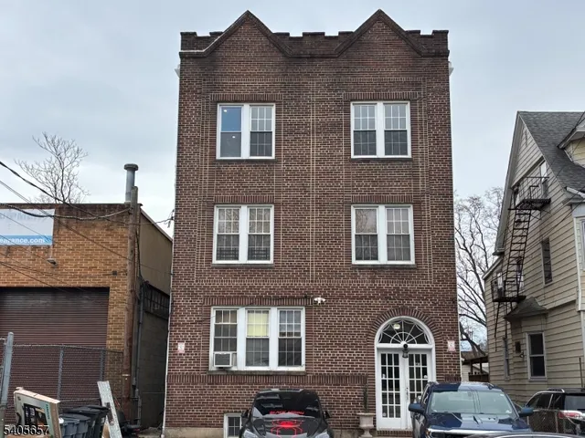 a front view of a building with parking space