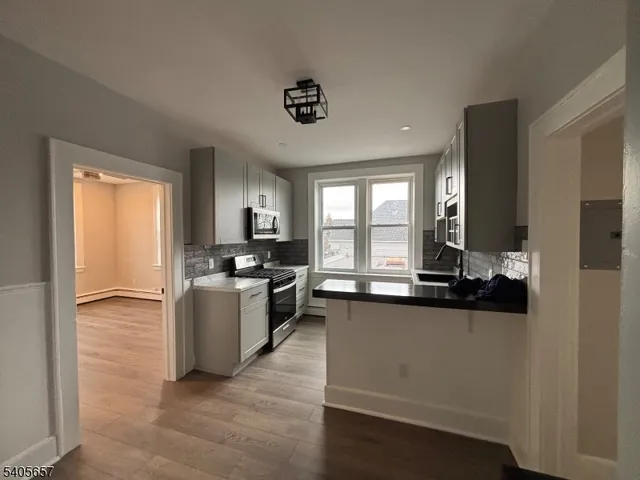 a kitchen with a sink appliances cabinets and a counter top space