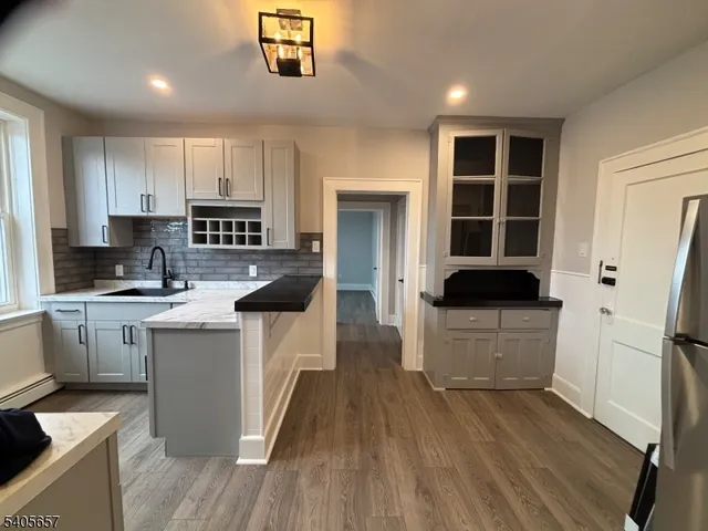 a kitchen with white cabinets and appliances