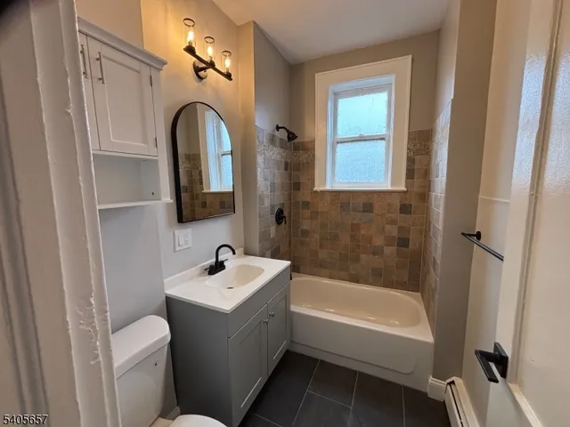 a bathroom with a sink a toilet and a bathtub