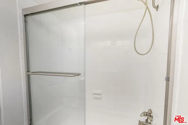 a bathroom with a glass shower door