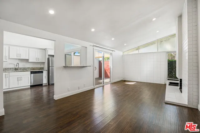 a view of a kitchen with a sink and a stove top oven