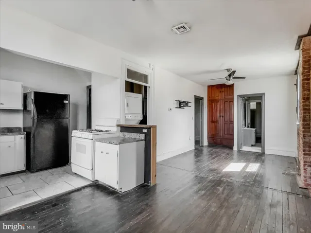 a kitchen with stainless steel appliances granite countertop a refrigerator and a stove top oven