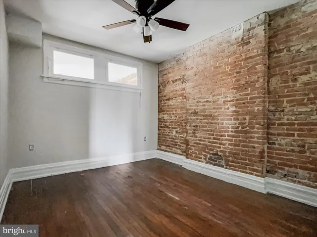 an empty room with wooden floor and closet
