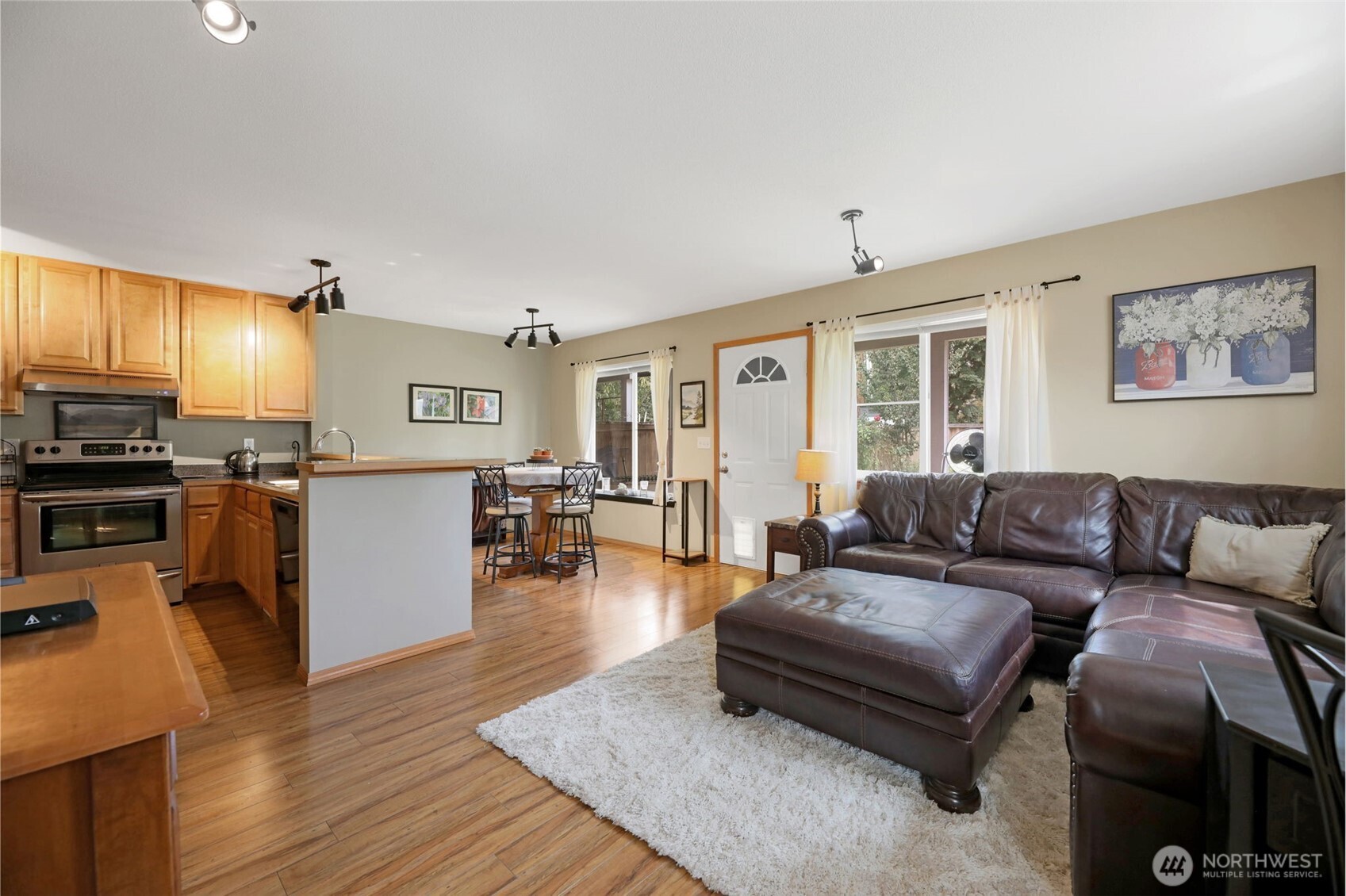 17872 155th Place Southeast, Unit 2 Monroe, WA 98272 - Photo 6 of 19 a living room with furniture and a wooden floor