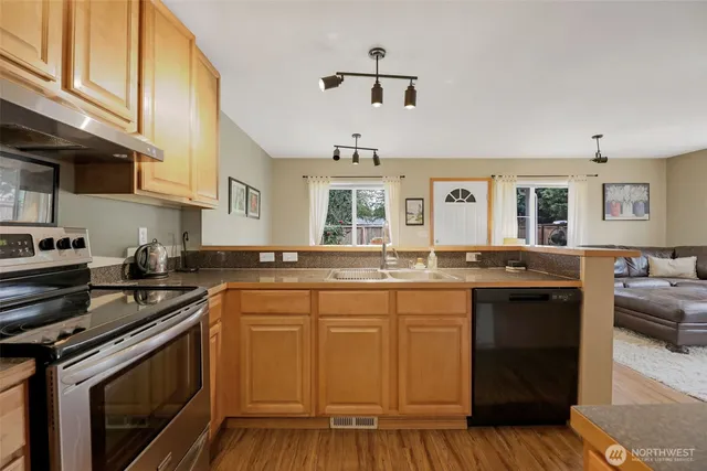 a kitchen with a sink stove and cabinets