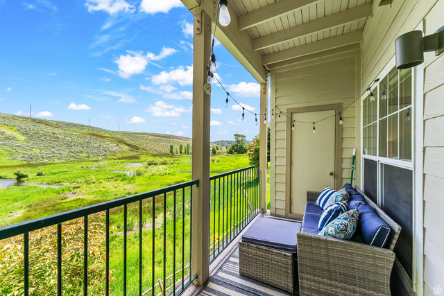 900 Bitner Road, Unit K25 Park City, UT 84098 - Photo 21 of 35 Covered balcony featuring a black metal railing and expansive green landscape