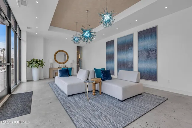 a living room with fireplace furniture and a chandelier