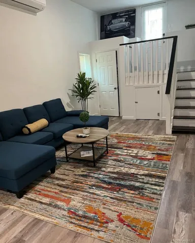 a living room with furniture and a potted plant