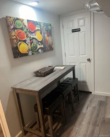 a dining room with furniture and wooden floor