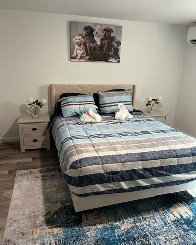 a bedroom with a bed and painting on the wall