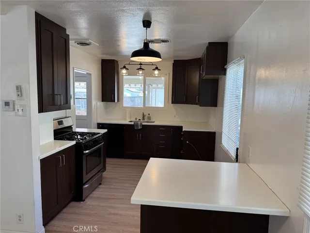 a kitchen with a sink dishwasher a stove and a refrigerator
