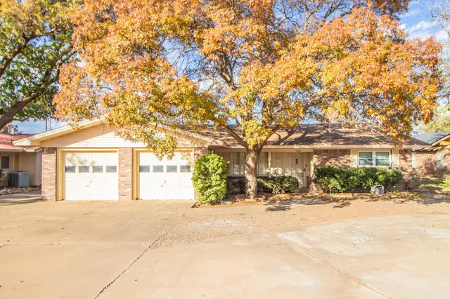 a front view of a building with snow on the road