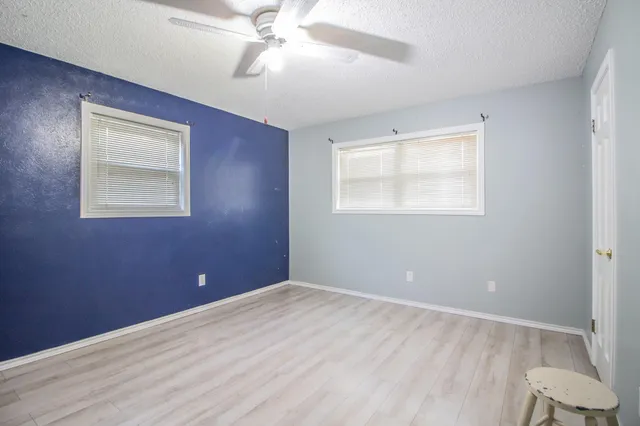 a bathroom with a granite countertop sink mirror and shower
