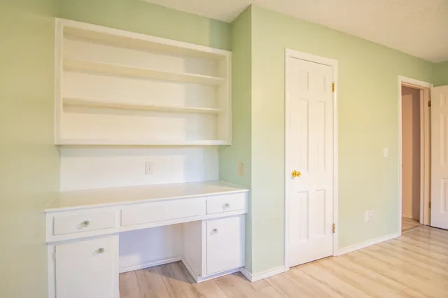 a front view of house with yard space and trees around