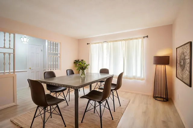 a view of a dining room with furniture and a potted plant