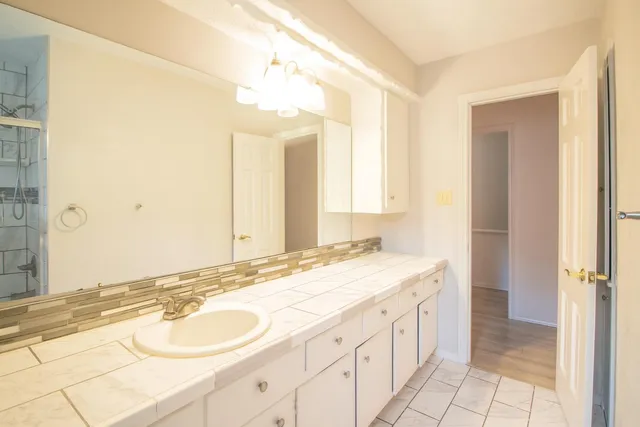 a front view of a house with a yard and potted plants