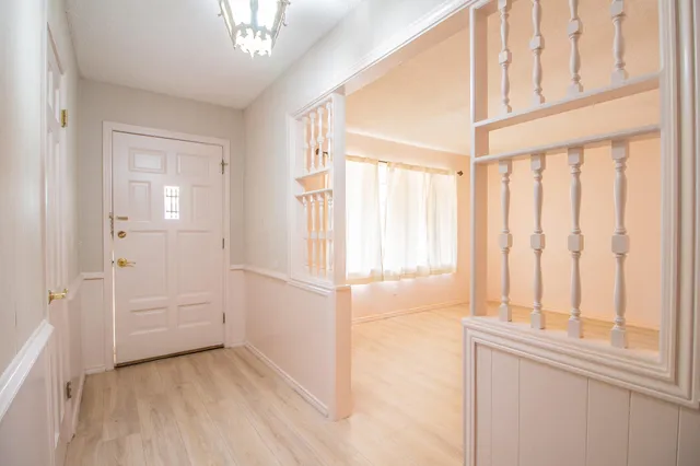 a living room with fireplace furniture and a large window
