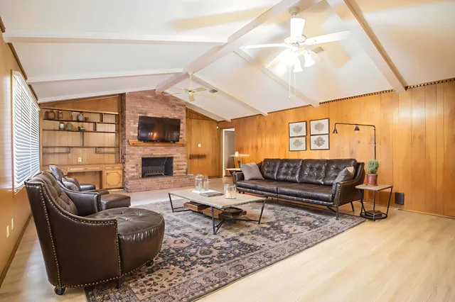 a view of an empty room with a fireplace and a window