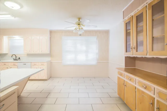 a kitchen with granite countertop white cabinets and white appliances