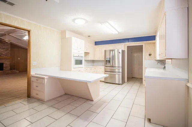 a view of a kitchen with white cabinets