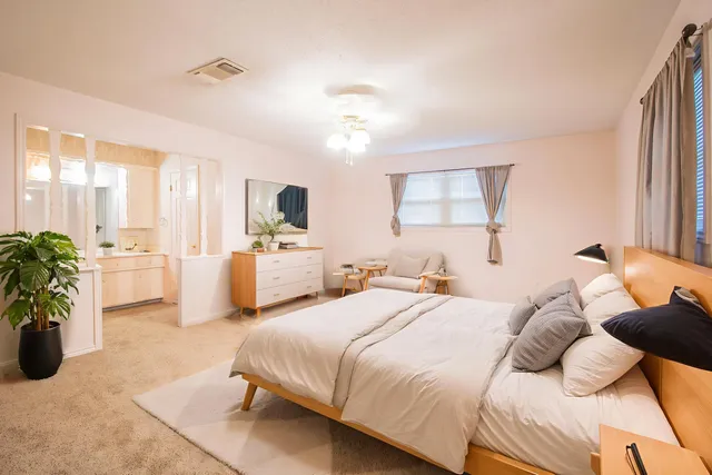 a bathroom with a double vanity sink toilet and shower