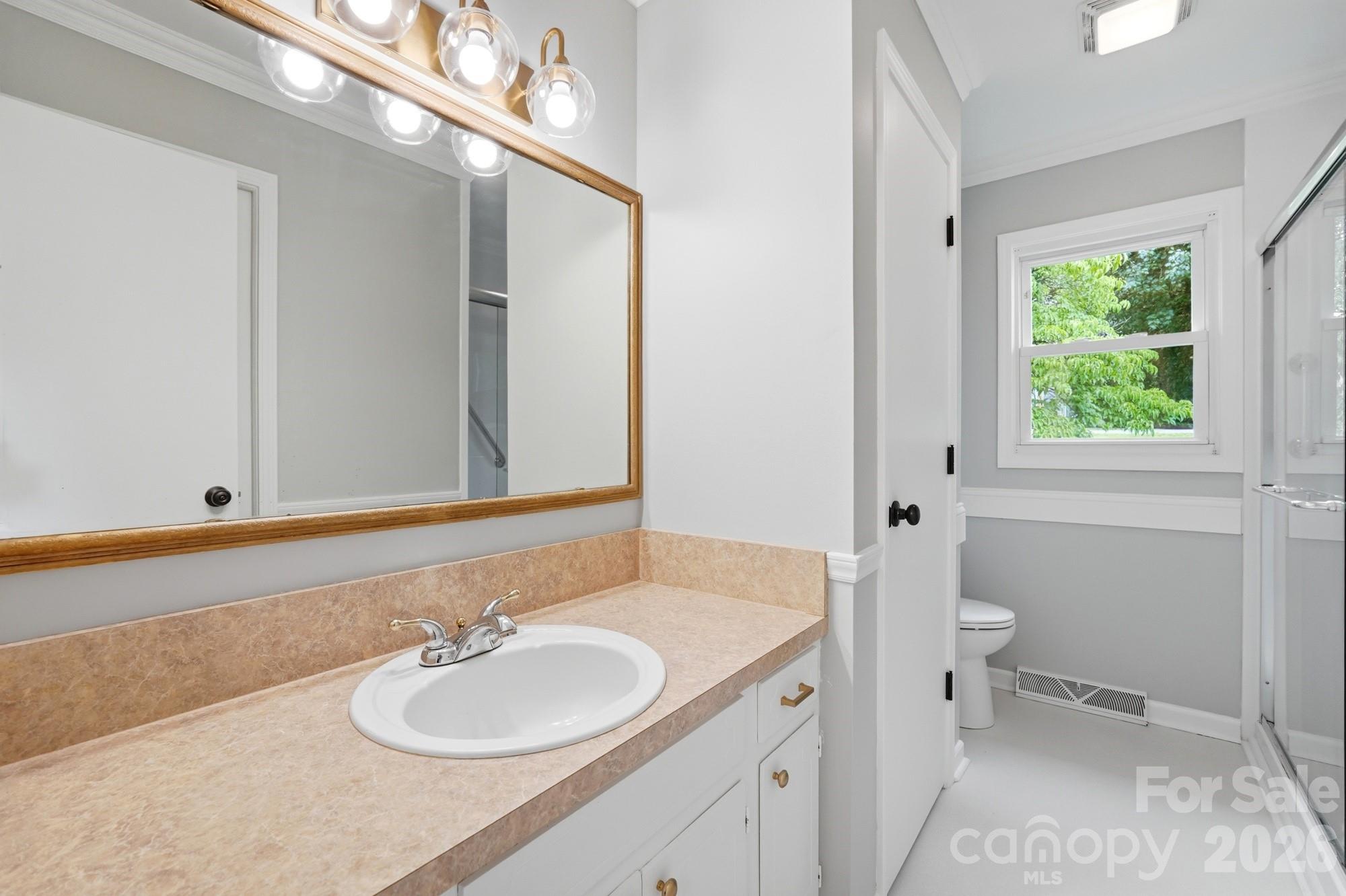 1235 Winecoff School Road Concord, NC 28027 - Photo 14 of 27 a bathroom with a granite countertop sink and a mirror