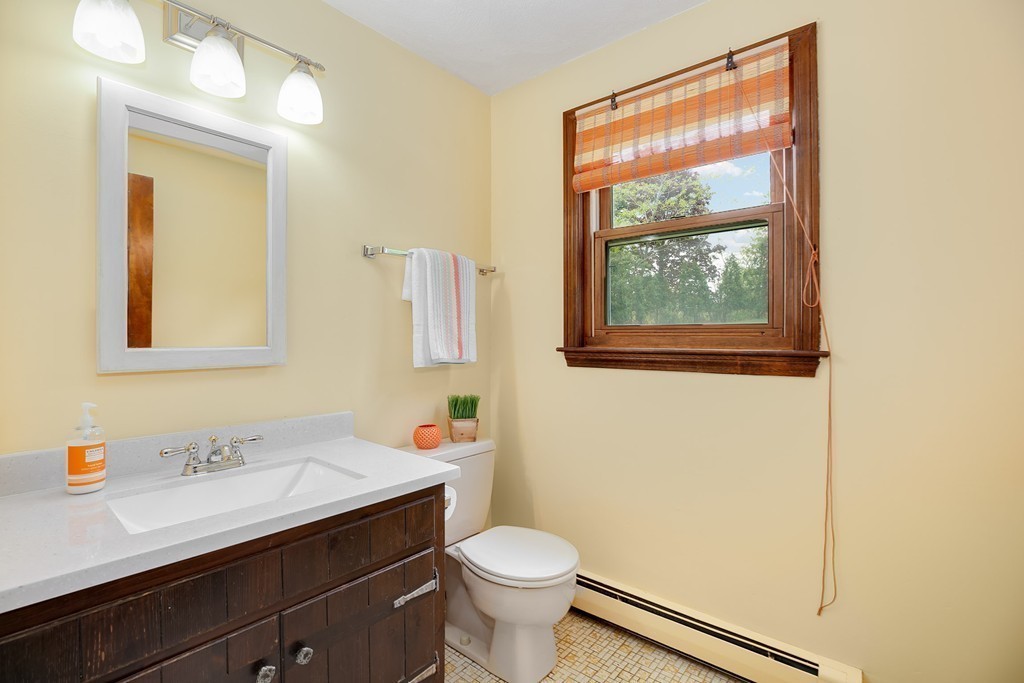 15 Barrett Road Lexington, MA 02421 - Photo 15 of 30 a bathroom with a sink a toilet and mirror
