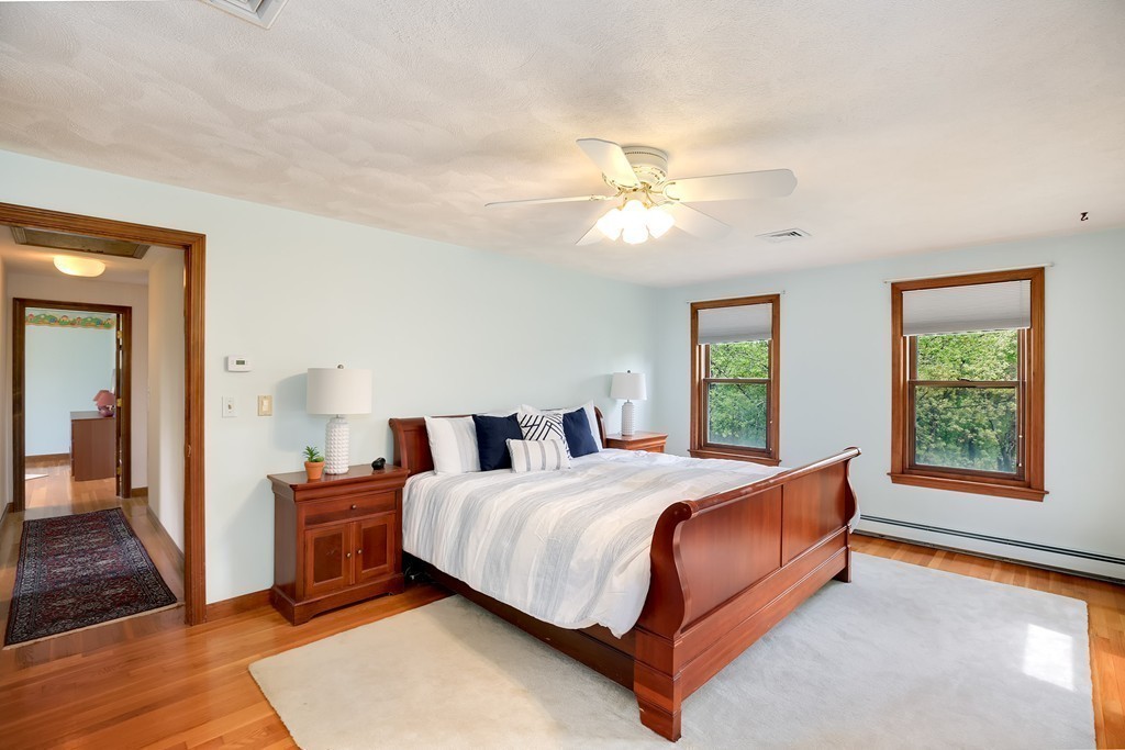 15 Barrett Road Lexington, MA 02421 - Photo 17 of 30 a bedroom with a large bed and a chandelier