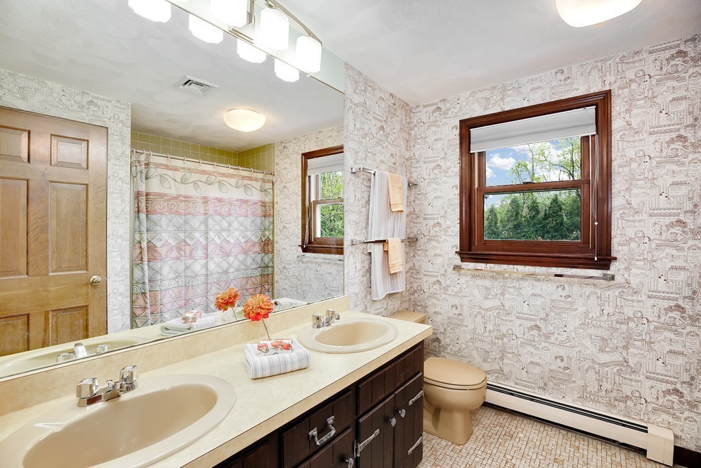 15 Barrett Road Lexington, MA 02421 - Photo 18 of 30 a bathroom with a sink a toilet a mirror and shower