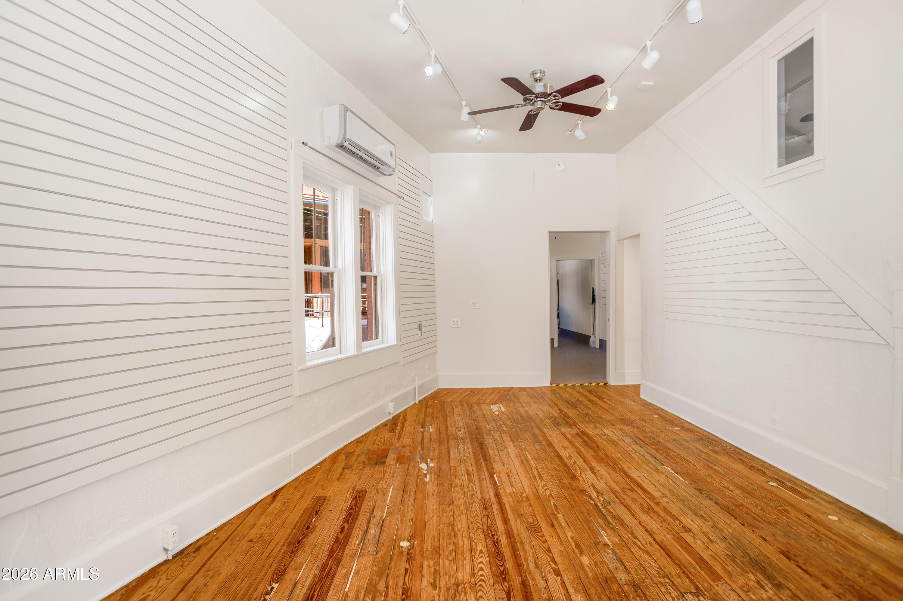 41 Main Street Bisbee, AZ 85603 - Photo 10 of 33 a view of a livingroom with a ceiling fan and wooden floor