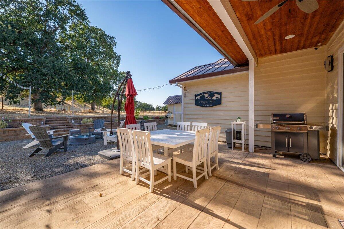 15775 Red Bank Road Red Bluff, CA 96080 - Photo 71 of 113 a view of a patio with table and chairs with wooden floor and fence