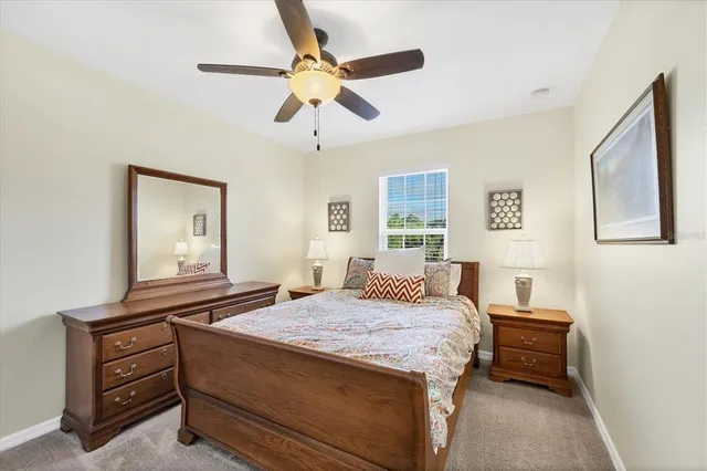 a bathroom with a granite countertop sink a toilet and a mirror