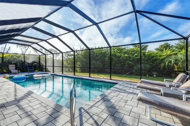 a view of swimming pool with seating area and furniture