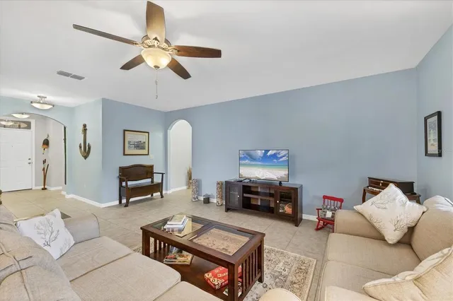 a kitchen with a table chairs refrigerator and microwave