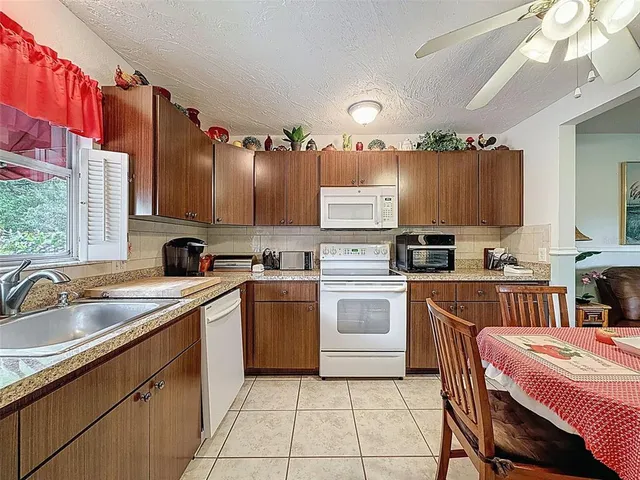 a kitchen with a sink cabinets and window