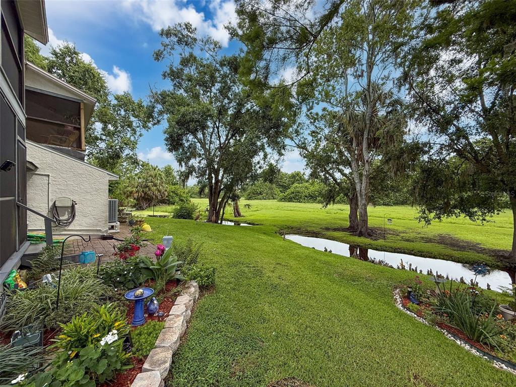 7135 Trenton Place New Port Richey, FL 34653 - Photo 2 of 50 a view of a garden with flowers and trees
