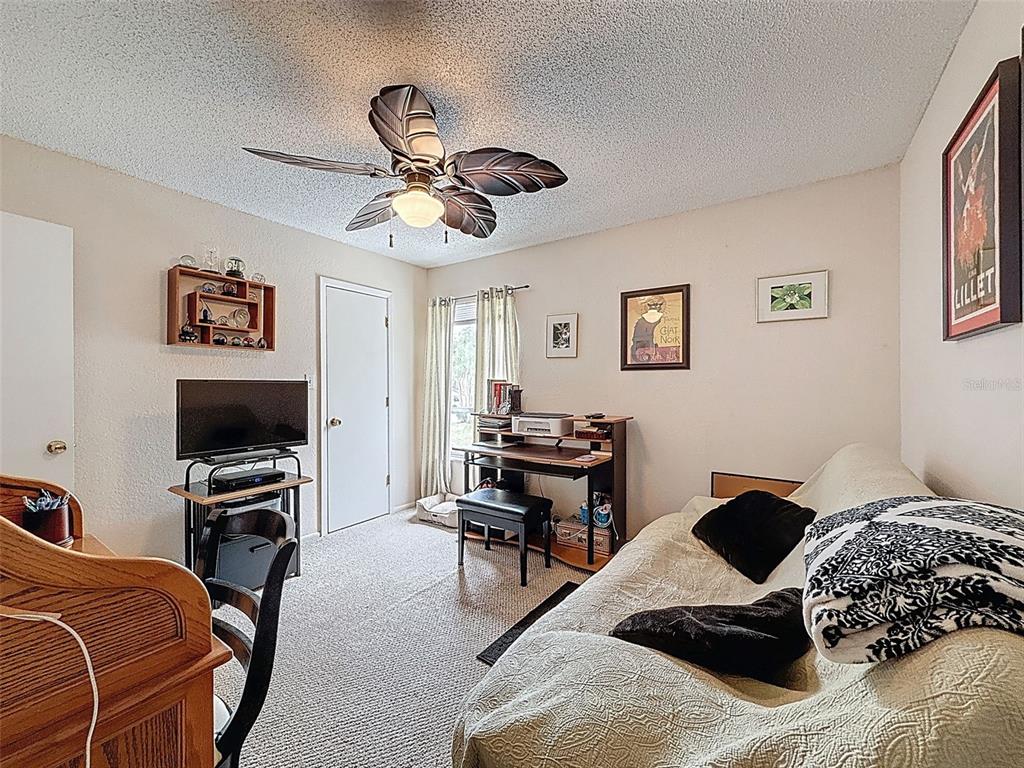 7135 Trenton Place New Port Richey, FL 34653 - Photo 24 of 50 a bedroom with a bed and a flat screen tv