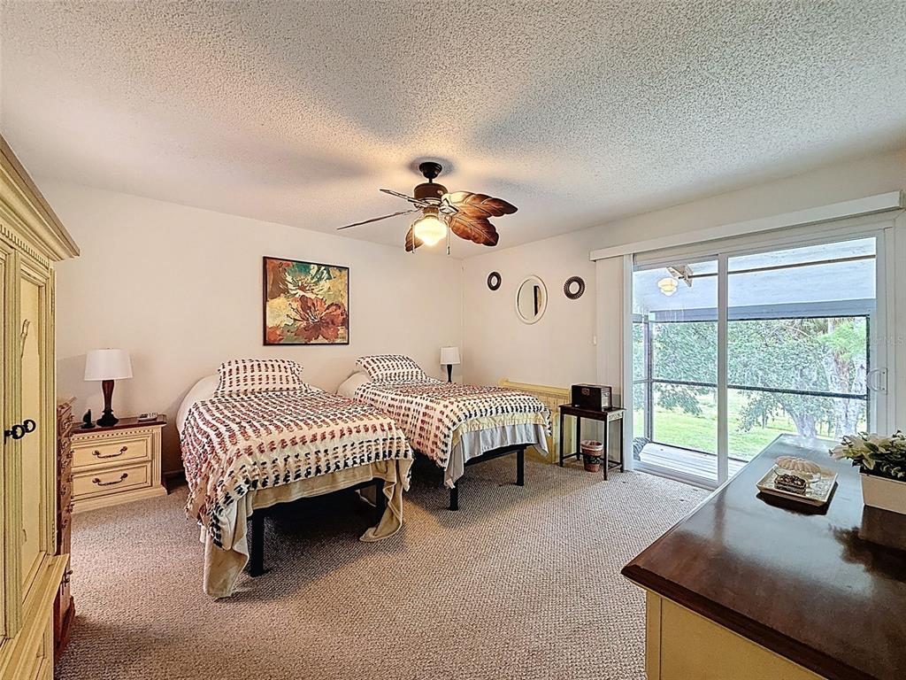 7135 Trenton Place New Port Richey, FL 34653 - Photo 25 of 50 a spacious bedroom with a bed and a large window