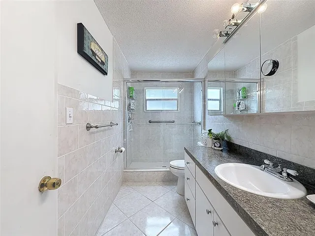 a view of two chairs in the balcony next to a yard