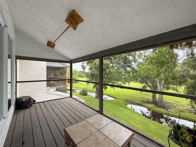 a view of a chairs and table in patio with wooden floor