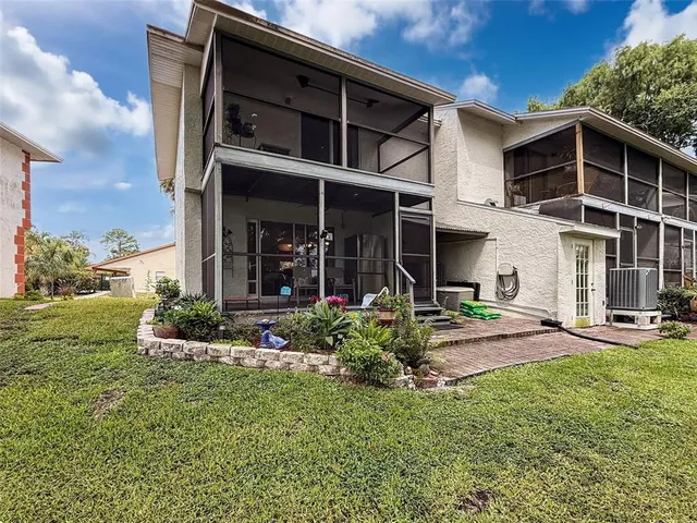 a view of a house with porch and garden