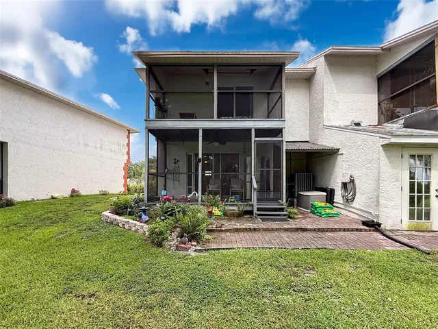 a view of a house with backyard and porch