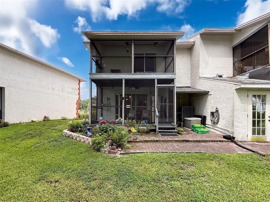 7135 Trenton Place New Port Richey, FL 34653 - Photo 37 of 50 a view of a house with porch and garden