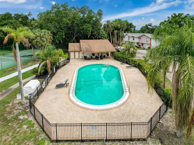 an aerial view of a house with a swimming pool and outdoor space