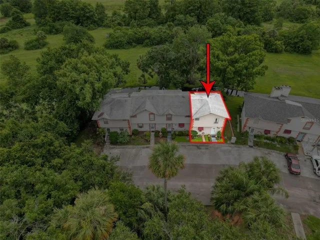 an aerial view of a house with a yard and lake view