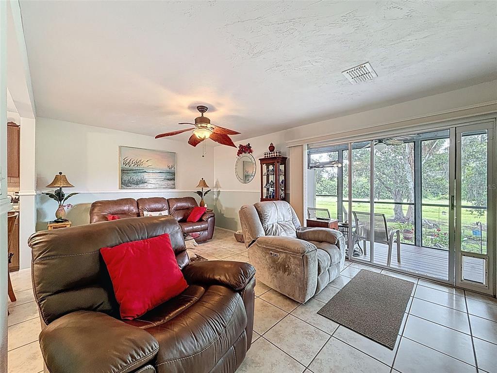 7135 Trenton Place New Port Richey, FL 34653 - Photo 8 of 50 a living room with furniture and a floor to ceiling window