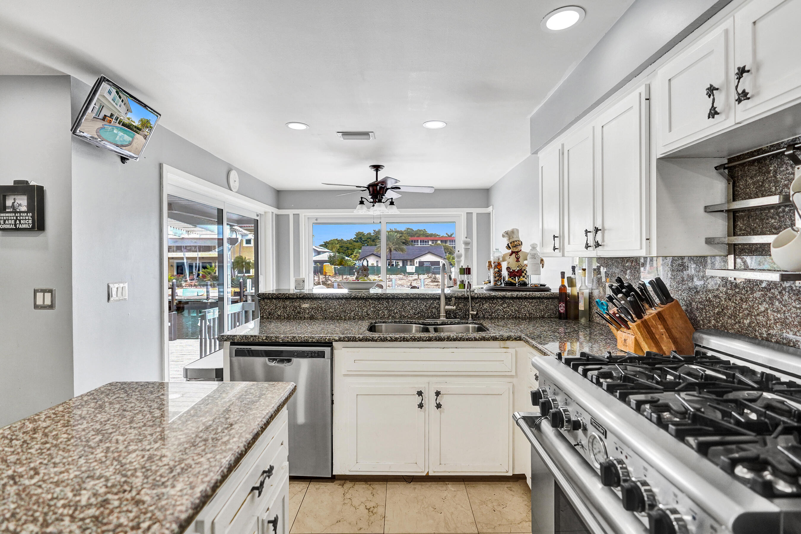 3001 Northeast 47th Street Lighthouse Point, FL 33064 - Photo 13 of 39 a kitchen with stainless steel appliances granite countertop a stove and a sink